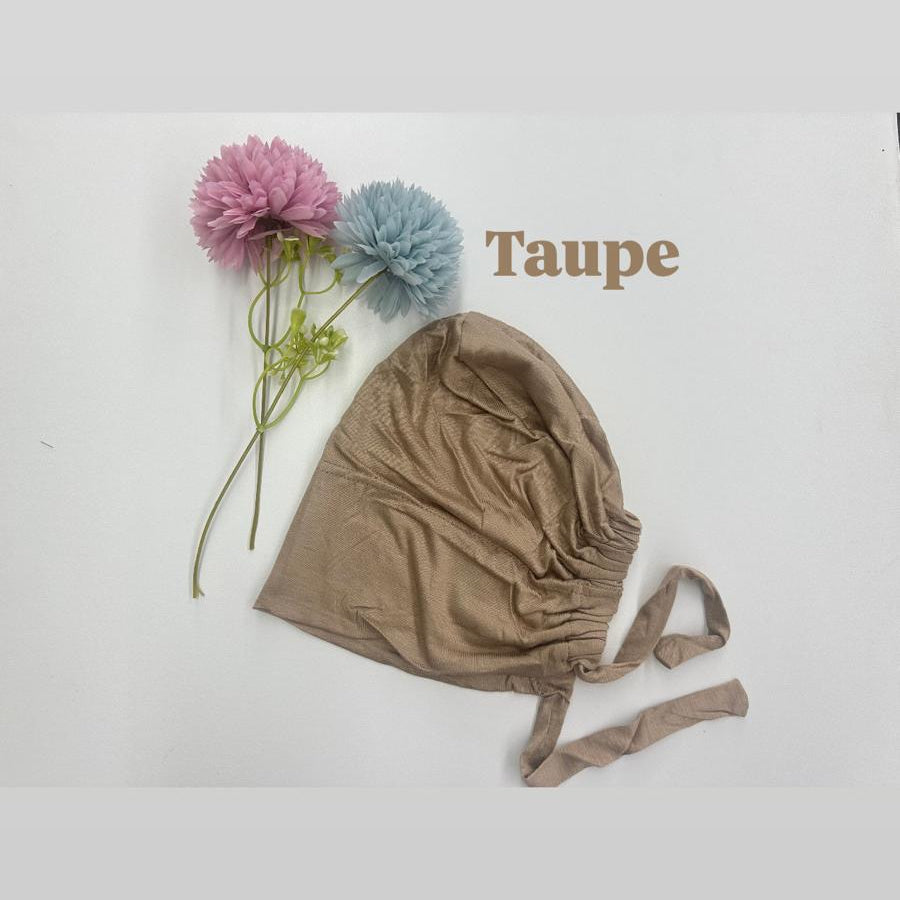 Taupe baby bonnet with flowers on a white background