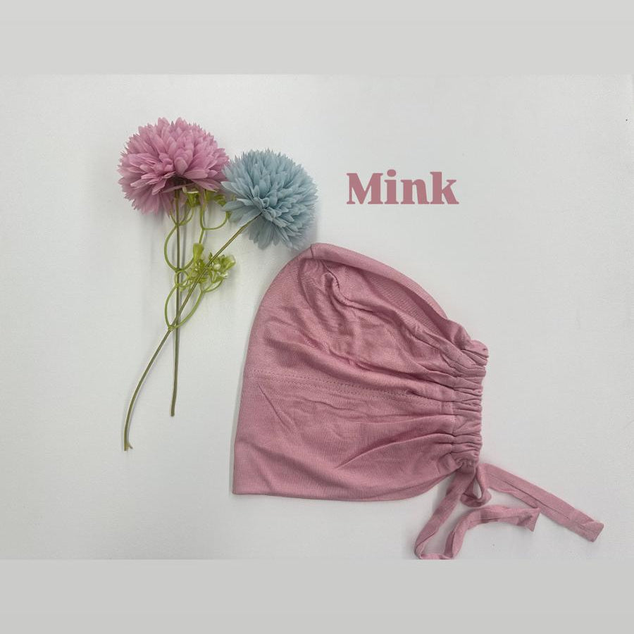 Pink baby bonnet with flowers on a white background, featuring the word 'Mink'.