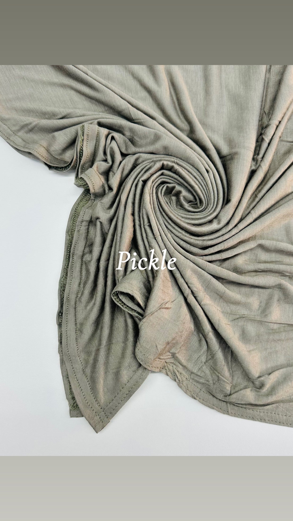Folded fabric with 'Pickle' text on a white background