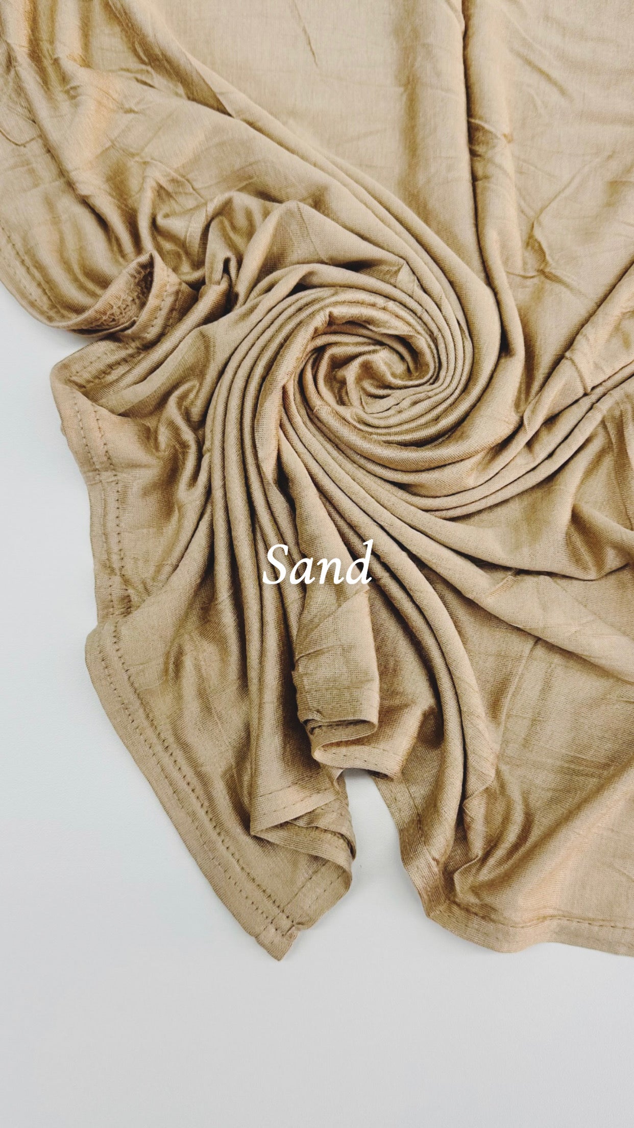 Beige fabric with 'Sand' label on a white background