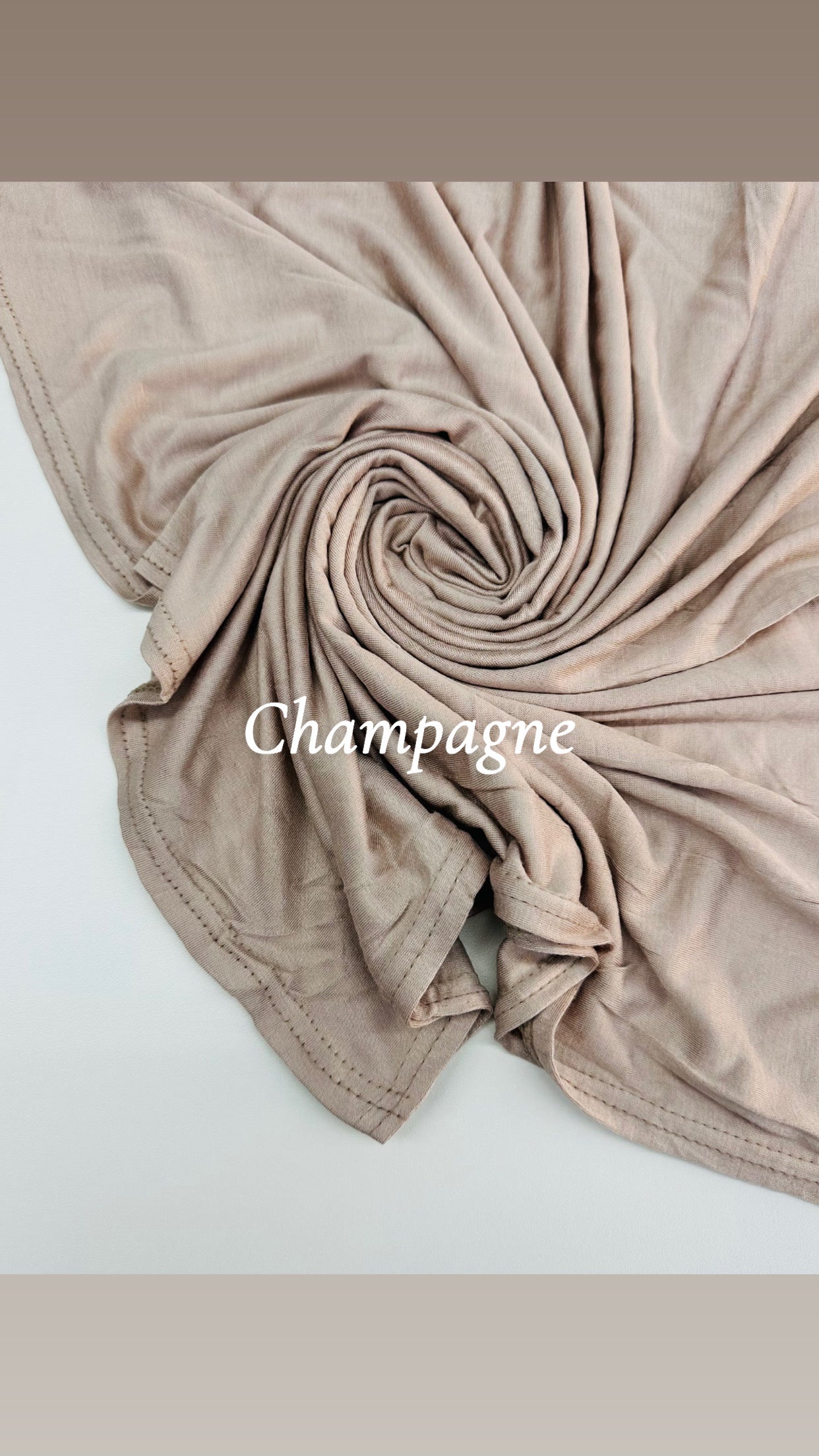 Folded beige fabric with 'Champagne' text on a light background