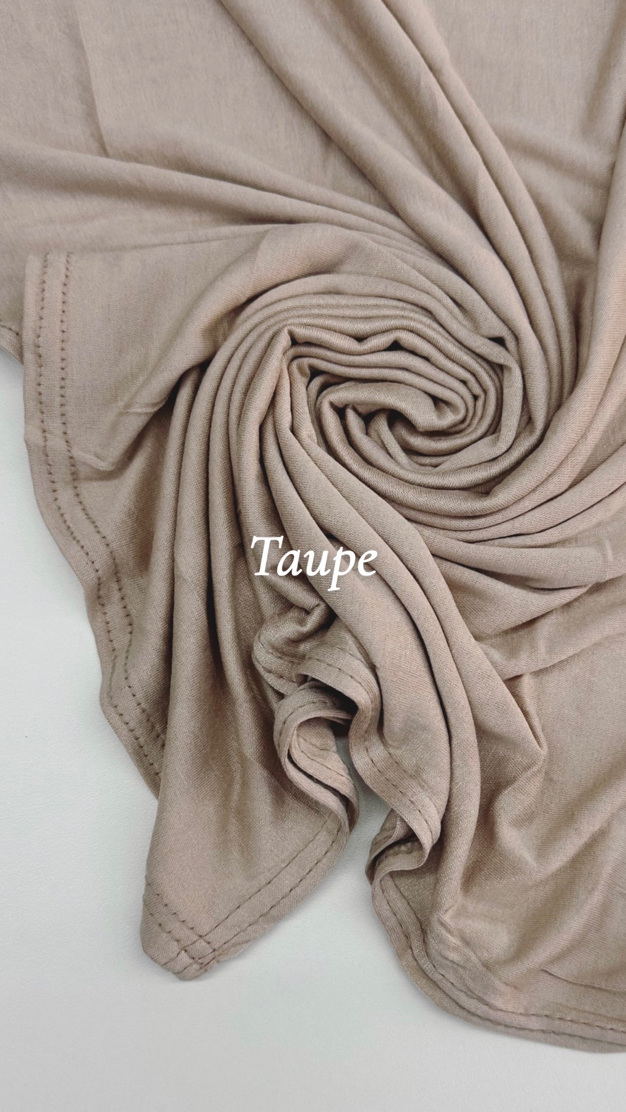 Close-up of taupe fabric with 'Taupe' text on a white background